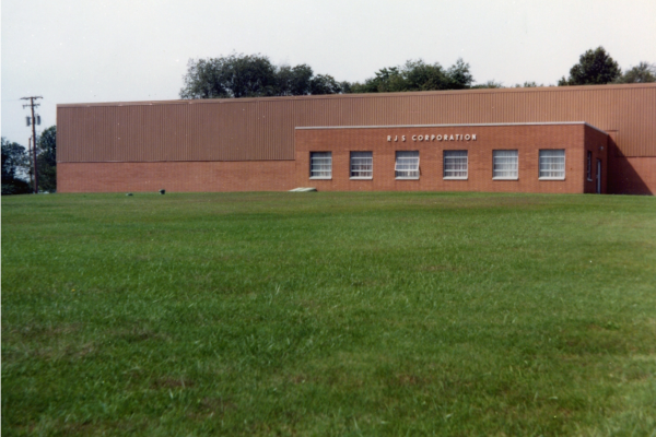A view of the front of the building after some grass but no shrubs or trees.